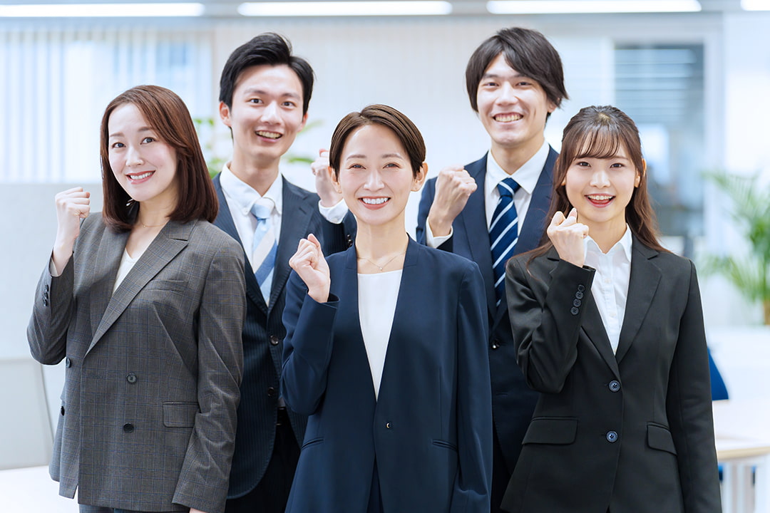 ガッツポーズをしている男女の社員5人